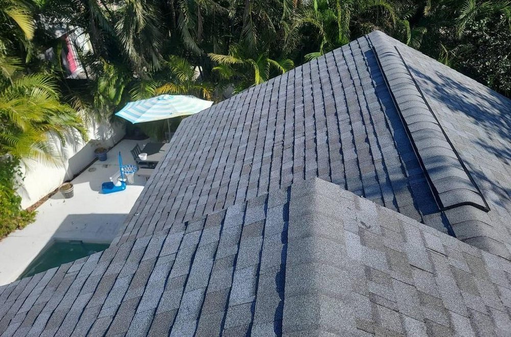Completed asphalt shingle roof with palms