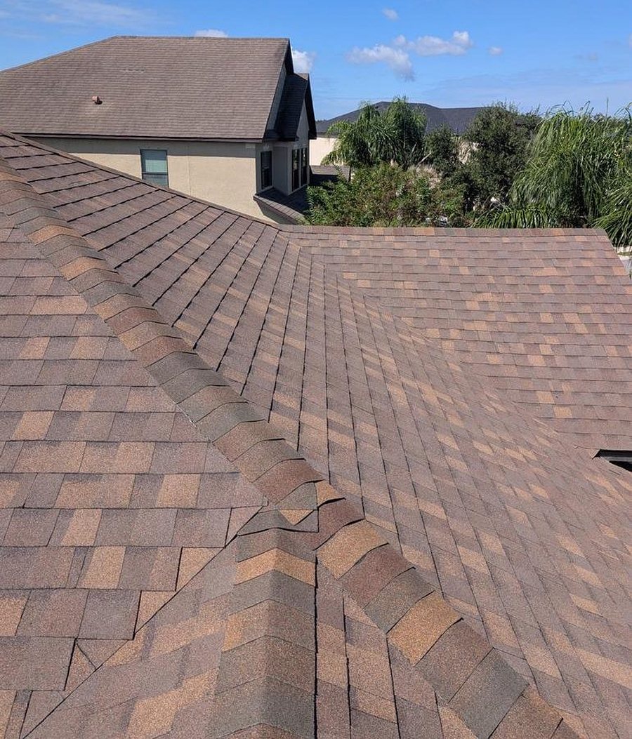 Shingle installation finished through the ridge